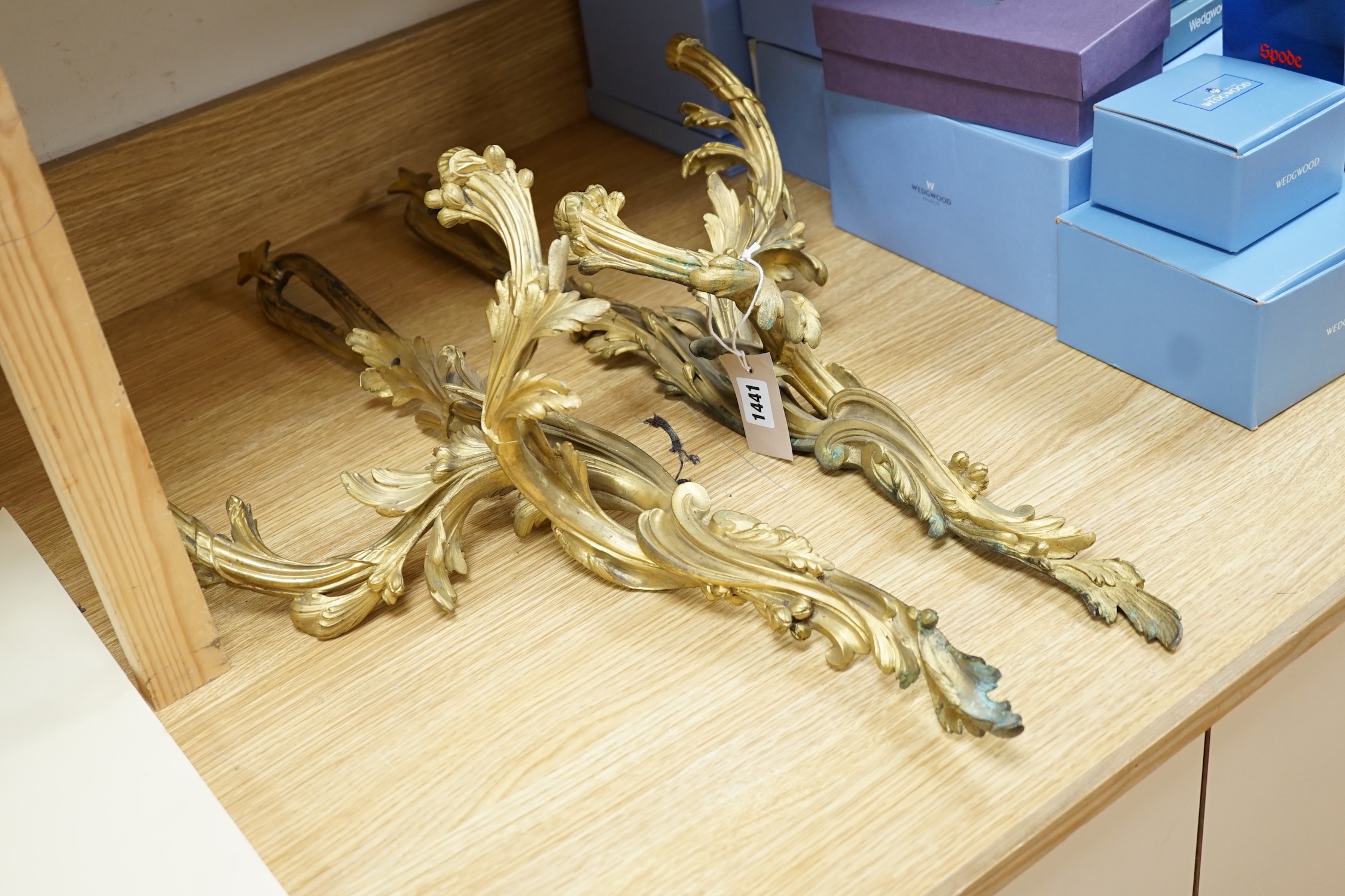 A pair of rococo style ormolu two branch wall lights, 76cm